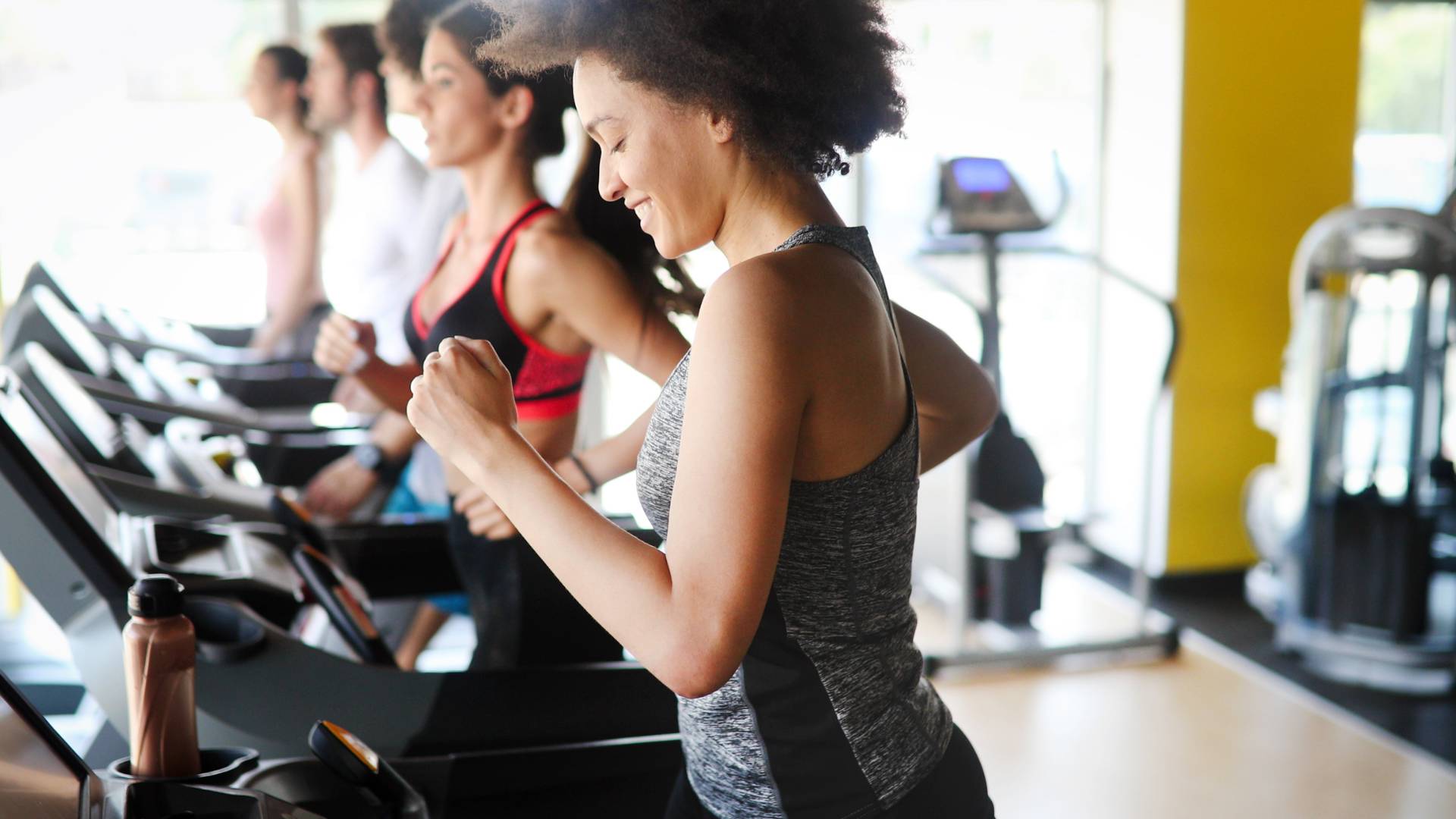 people running on treadmills in fitness center